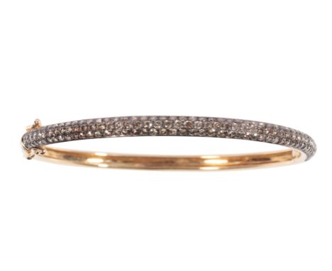 A CHOCOLATE DIAMOND HALF BANGLE set on unmarked yellow metal, with concealed clasp and safety hooks, approx 3.9gram total wei