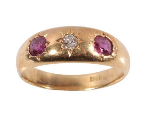 A RUBY AND DIAMOND GYPSY STYLE RING set with two oval-cut rubies and  a single brilliant-cut diamond, on an 18ct yellow gold 