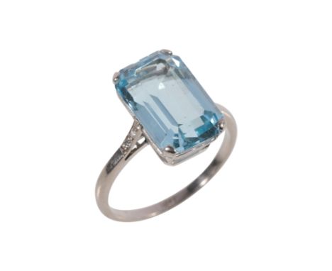 AN AQUAMARINE AND DIAMOND RING the aquamarine 13mm x 8mm, claw-set on an 18ct white gold shank, with diamond set shoulders, r