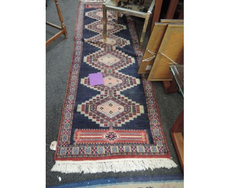 A modern carpet runner in the Bokhara style having blue ground