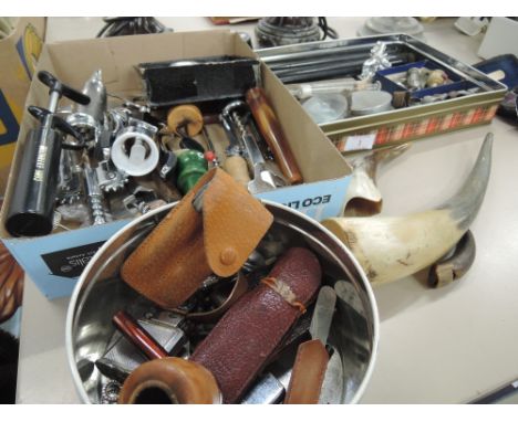 A miscellaneous lot including a collection of thimbles, corkscrews, bottle openers, cigarette lighters, driving goggles compa