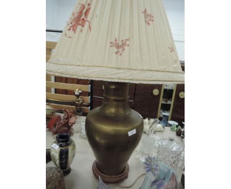 A large brassed urn shaped lamp and shade
