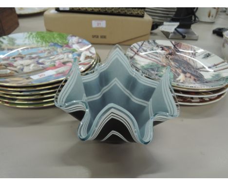 A collection of Edwardian sporting themed collectors plates, animal themed plates and a black and white art glass dish