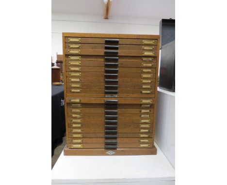 An oak 20 drawer watch makers cabinet with contents mainly 20th swiss watch parts boxed and labelled including stews, balane 