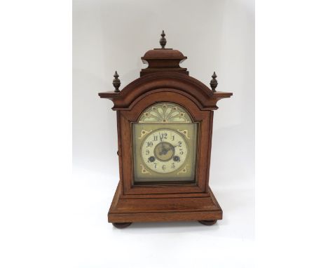 A German walnut cased architectural form striking mantel clock with Junghans movement, with pendulum. 42cm high 