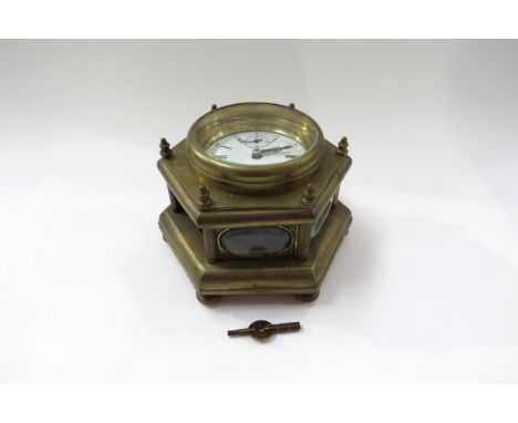 A 20th Century brass hexagonal form table clock with Roman enamelled dial, one glass panel missing. 14.5cm high 