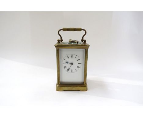 A 20th Century French brass carriage clock with white face, Roman numerals with key.  13cm tall x 8.5cm x 7.5cm 