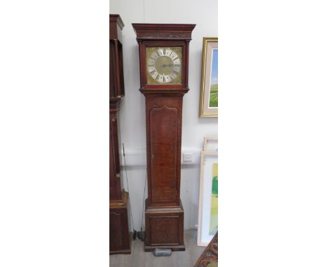 An 18th Century 30-hour longcase clock in oak case. Brass 11" dial with mask spandrels and Roman chapter ring signed WM. Cart