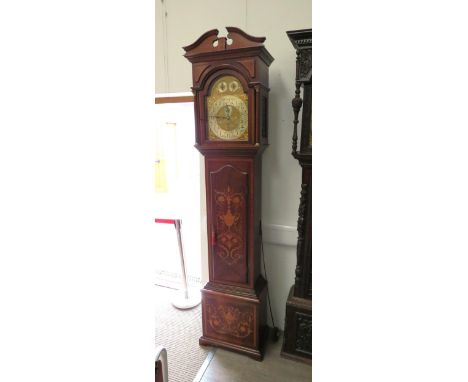 An Edwardian mahogany and inlaid longcase clock with quarterly 8 bell chimes and striking the hours on a gong. Brass arched d