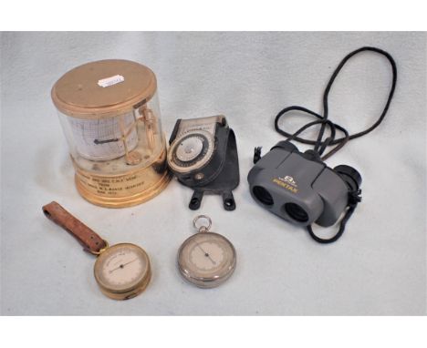 A SMALL BRASS POCKET BAROMETER and another similar inscribed on the back ' To George Herbert Evans From The Rev Latham Wickha