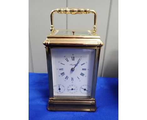 A FRENCH REPEATING CARRIAGE CLOCK, WITH CALENDAR AND ALARM DIALS the dial signed 'Angelus'  19cm high including handle (worki
