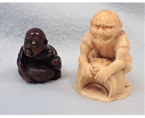 TWO NETSUKE one ivory and one wooden with an inset signature