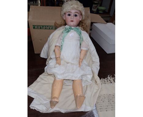 A HEINRICH HANDWERCK BISQUE HEADED DOLL 65 cms high, fully marked (head intact, limbs a bit worn, with some original clothing