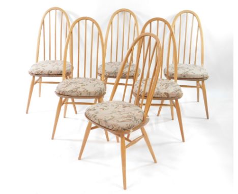 A set of six Ercol light elm and beech Quaker style stick back dining chairs, raised on turned legs united by an H frame stre