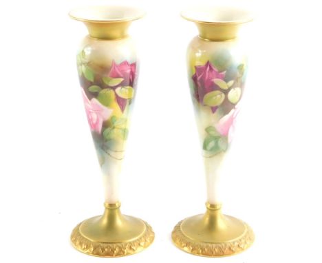 A pair of Royal Worcester blush porcelain vases, c1912, of tapering footed form, painted with roses, No 1931/15.51, printed a