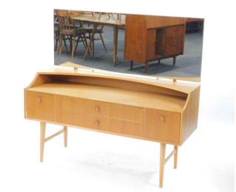 A Meredew mid-century vintage light oak dressing table, the tilting adjustable rectangular mirror over two long drawers, flan