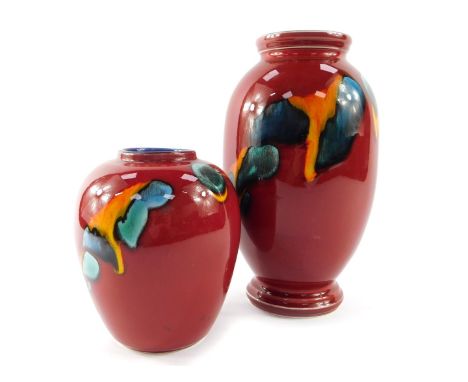 A Poole pottery vase decorated in the Volcano pattern, of baluster form, raised marks, 25cm high, and a further vase 15cm hig