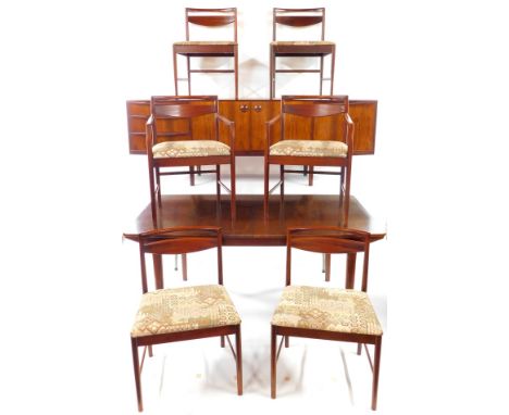 A McIntosh and Co Limited 1960's Rosewood dining suite, comprising a sideboard, with a pair of doors opening to reveal a shap