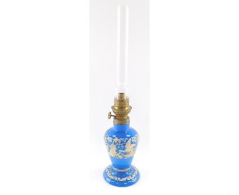 A Gaudard late 19thC blue glass oil lamp, with gilt and white enamel renaissance style decoration, with chimney, 44.5cm high.
