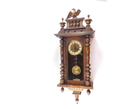 A German late 19thC walnut and oak Vienna wall clock, circular brass dial with enamel chapter ring bearing Roman numerals, ei