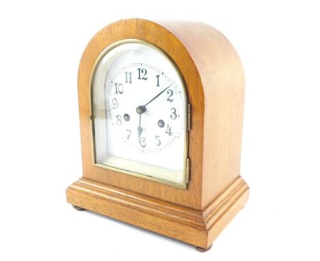 A German late 19thC oak cased mantel clock, the white tin dial bearing arabic numerals, Wurtemberg eight day movement with co