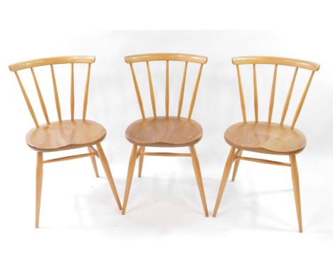 A set of three Ercol blonde elm and beech single dining chairs.