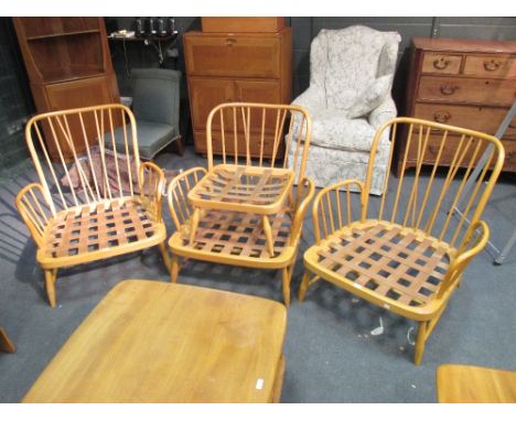 An Ercol armchair together with two others and two foot stools (5)  