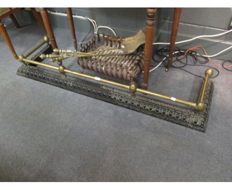 A brass and cast iron fire fender, together with a set of fire tools and a fire basket  