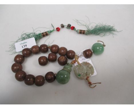 Part of an Agilawood Mandarin's necklace with green hardstone and jade beads and pendants together with a pair of jadeite pen