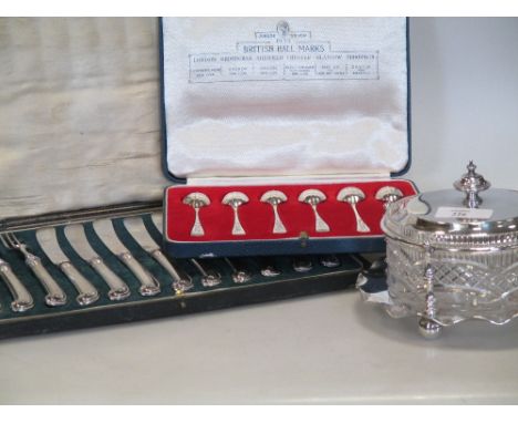 A silver butter dish together with a silver backed hairbrush, mirror, and comb, a cased set of six silver teaspoons, a silver