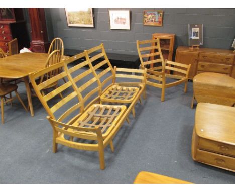 An Ercol elm three seater sofo together with two matching armchairs (No cushions) together with a footstool (4)  