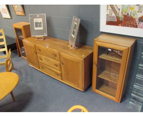 An Ercol blonde elm Windsor sideboard together with a pair of Ercol glazed wall cupboards  