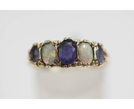 A 9 carat gold sapphire and opal ring, with five alternate set graduated stones, finger size R1/2, 2.9 g gross, cased