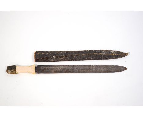 A Sudanese short sword with Arabic script to the blade, bone handle with crocodile skin mount and scabbard, blade 41cm long