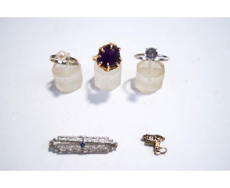 A single stone cultured pearl ring, stamped '14K', finger size K1/2, 2 g gros; two dress rings; an American single stone set 
