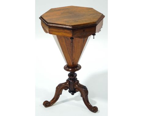 A Victorian rosewood work table, the octagonal compartmental box upon an inverted column and carved scroll legs, 71cm high