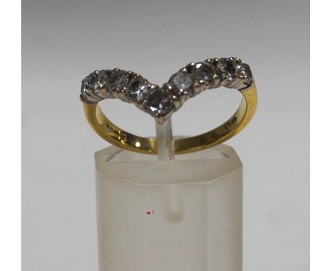 An 18 carat gold diamond wishbone ring, the nine brilliant cuts totalling approximately 0.8 carats, finger size P, 3.9 g gros