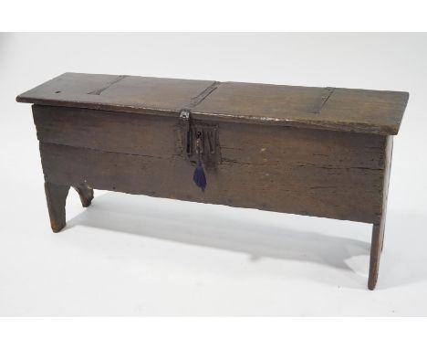 An early 17th century oak four plank coffer, with iron strapwork hinges , lock and key, 63cm high x 149cm wide x 40cm deep. P