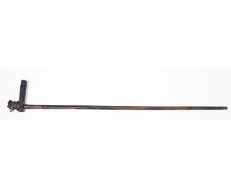 A walking stick with the handle carved as a chicken