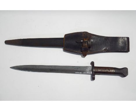 A WWII British Enfield bayonet, pattern 1888, with leather and metal mounted scabbard