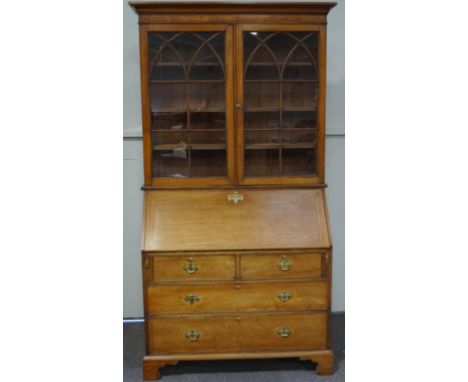 A 19th Century mahogany bureau bookcase, the upper section with glazed astragal doors over a fall front, enclosing a fitted i