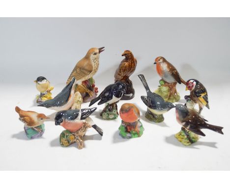 A collection of figures of birds, four Royal Worcester, seven Beswick and one other