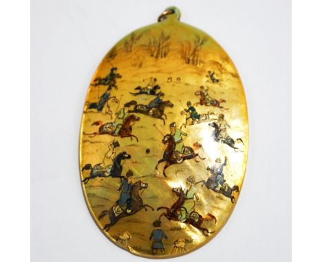 A Persian mother of pearl painted shell pendant, depicting a polo game, 8.2 cm long