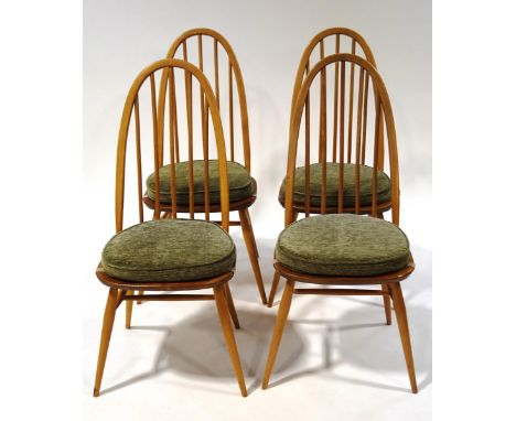 A set of four Ercol beech stick back kitchen chairs