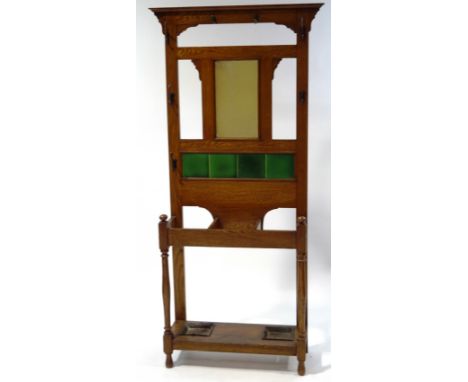 A cast iron stick stand with nine hooks in three ties, 184cm high