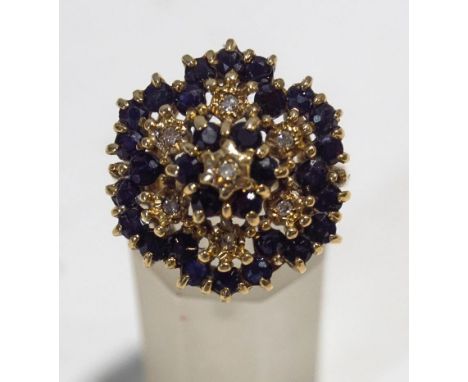 A 9 carat gold sapphire and illusion set diamond cluster ring, finger size N, 6.8 g gross