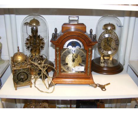 Two domed Skeleton clocks, together with a moon clock, etc.  CONDITION REPORT brass lantern clock is electricOur team of trus