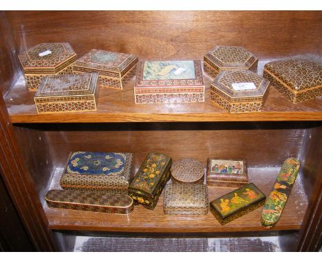 Two shelves of wooden and papier mache trinket boxes 