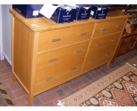 A contemporary light oak G-Plan double width chest of drawers - width 142cms