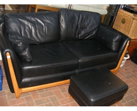 An Ercol black leather sofa with matching footstool CONDITION REPORT Approximate dimensions:Height, 73cmWidth, 195cmDepth, 95